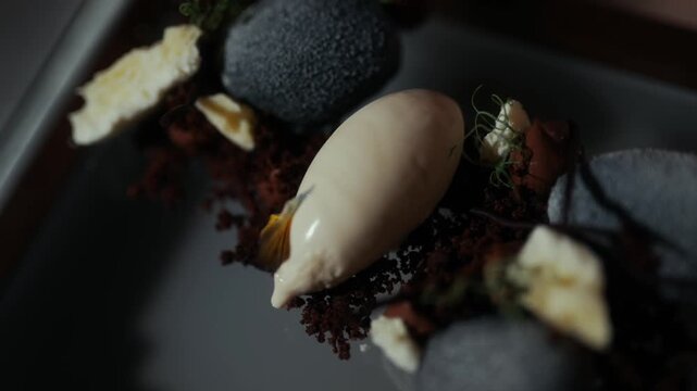 Artistic dessert plating with mousse and dark sponge cake