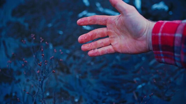 Close-up Of A Hand Breaking A Layer Of Ice During Winter, Cracked Ice Pieces.