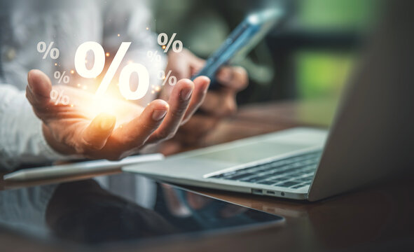 Interest Rate and Financial Growth Concept with Cupped Hand Holding Glowing Percentage Symbols.
