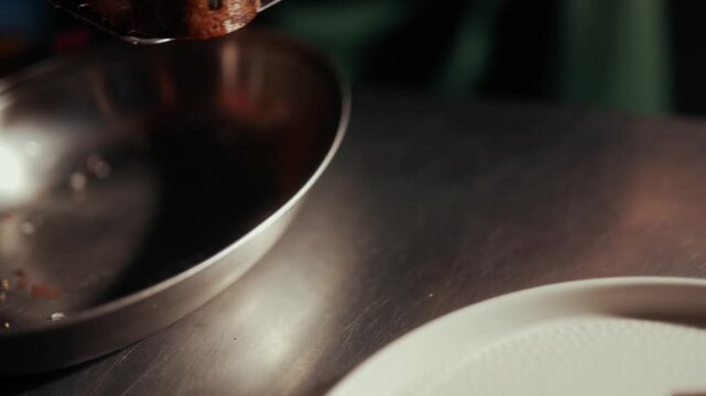 Hands shaping dark chocolate truffle with cocoa powder coating