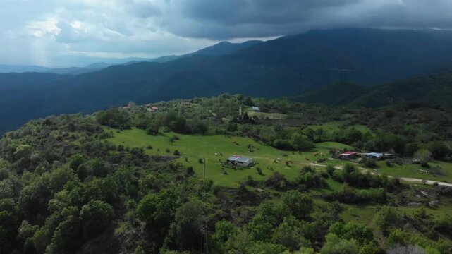 Aerial view of Livaditis, a high-altitude mountain village surrounded by dense forests and green meadows in the Xanthi Region of Eastern Macedonia and Thrace, Greece.