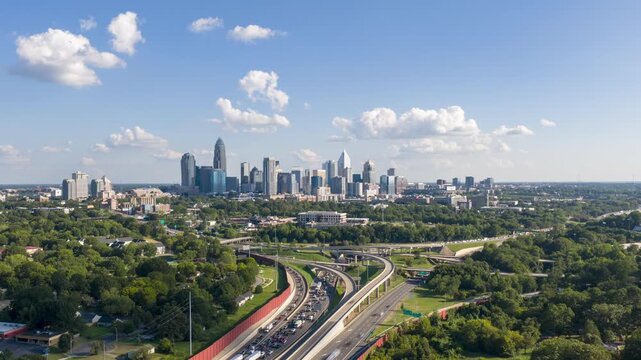 Drone hyper lapse of downtown Charlotte aka uptown catching afternoon traffic build up with nice clouds on a nice sunny day