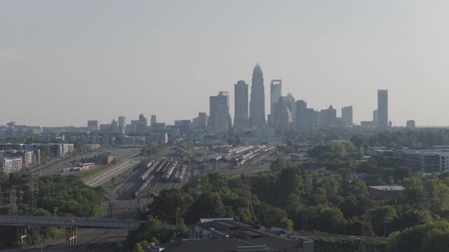 2x Drone footage of downtown Charlotte aka uptown overlooking a apartment building and train tracks heading towards charlotte north Carolina bottom to top pan