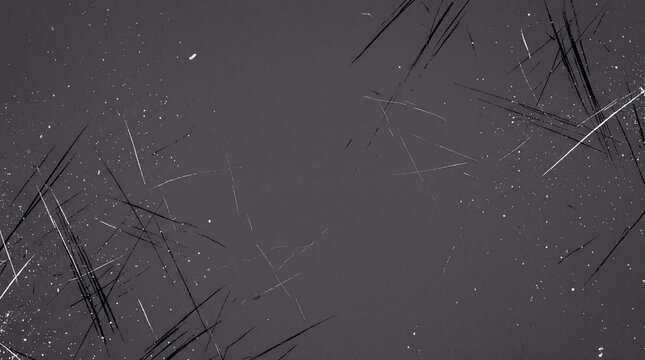 A dark gray background with numerous fine white scratches and dust particles, creating a textured and slightly distressed surface