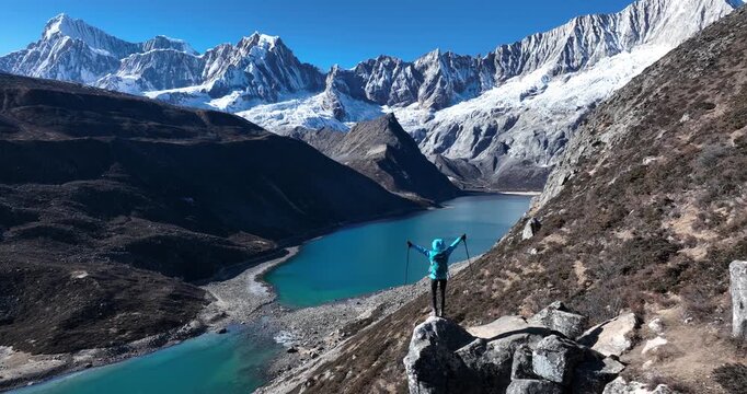 Backpacking woman hiking on high altitude mountain top