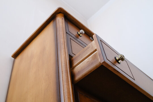 Opened retro wooden wardrobe drawer low angle view