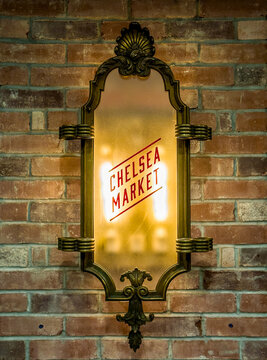 Manhattan, NY, USA, June 17, 2026: An illuminated glass sign marks the entrance to Chelsea Market, a historic food hall and shopping complex in New York City's Meatpacking District.