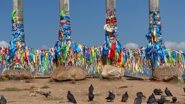 Baikal Lake. Video of sacred site on Olkhon Island, near  Khuzhir. Tourists, pilgrims, Buddhists come to Cape Burkhan to tie colorful ribbons, Hadaks, Buddhist prayer flags on 13 Serge pillars