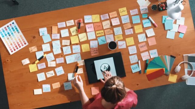 Time lapse of skilled business woman hold tablet with logo design at meeting. Marketing team working on tablet and walking around table and looking at sticky notes from brainstorming idea. Symposium.