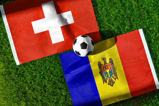 Switzerland vs. Moldova football match. National flags on green grass with soccer ball in the middle. Football background for international match.