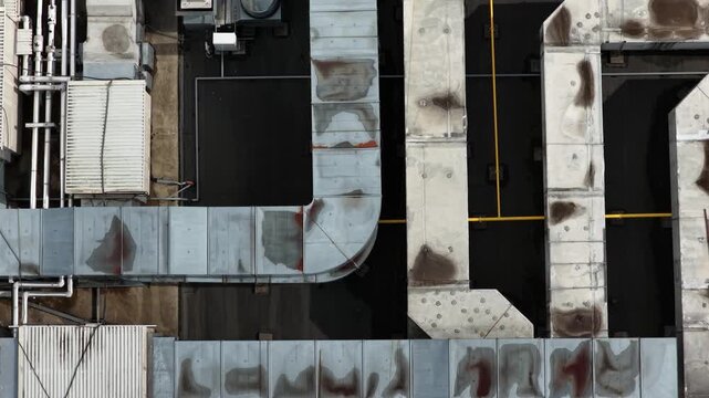 Aerial top view of industrial rooftop ventilation and HVAC duct system