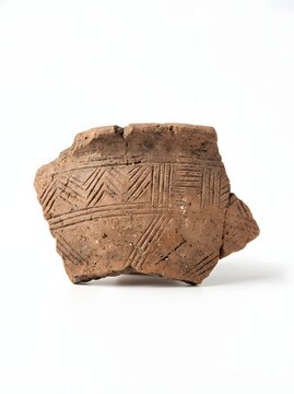 Ancient pottery shard with etched geometric patterns