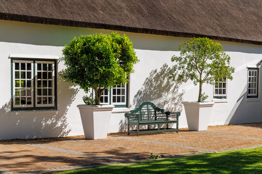 Cozy white house with thatched roof