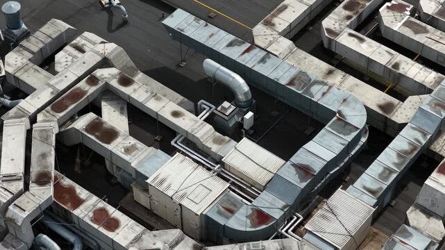 Aerial top view of industrial rooftop ventilation and HVAC duct system