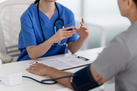 doctor discusses treatment options with a patient in a clinic visit