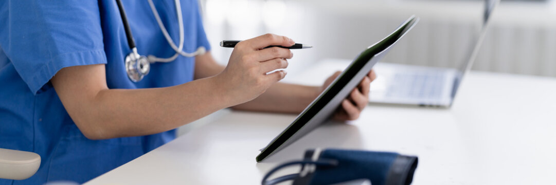 Medical doctor office desk with medical forms and clinical notes