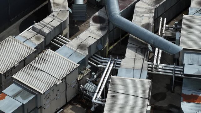 Aerial top view of industrial rooftop ventilation and HVAC duct system