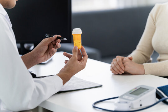A doctor explain a drug bottle with a patient in a hospital