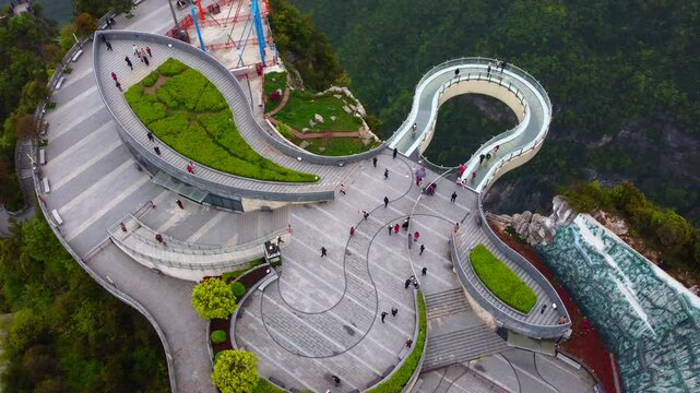 Aerial View of Modern Glass Suspension Bridge and Observation Deck Over Forested Canyon in China