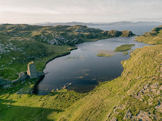 Obraz premium Aerial view of the ruins of Dunlough Castle, also known as Three Castle Head, dramatically situated on the Mizen Peninsula in County Cork, Ireland Cork, Ireland - 28 August 2026.