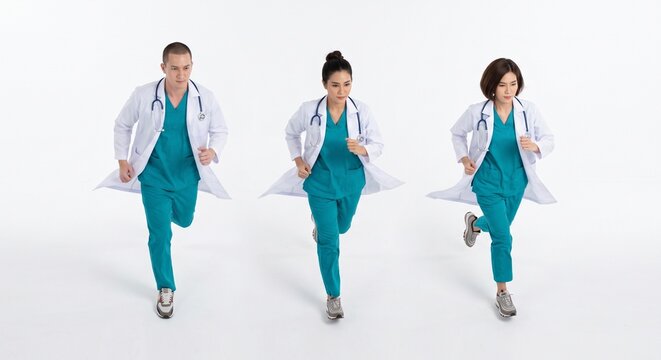 Group of medical doctors in teal scrubs running forward together