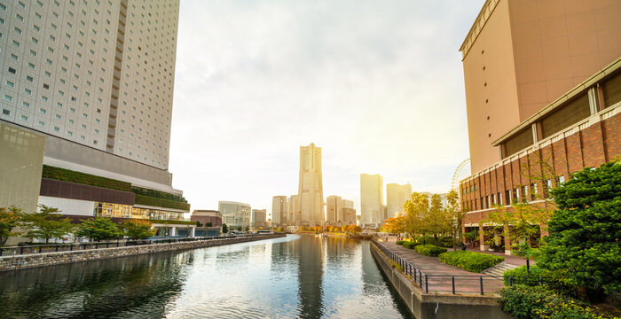 view of yokohama landmark tower and minato mirai city skyline, cityscape during golden hour sunset