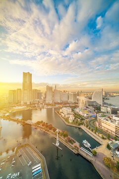 aerial view of yokohama landmark tower and minato mirai city skyline, cityscape during golden hour sunset