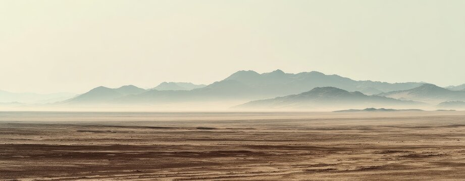 Vast, hazy desert landscape with distant mountains (1)
