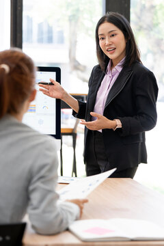 Asian Businesswoman Standing and Explaining Strategy in Meeting