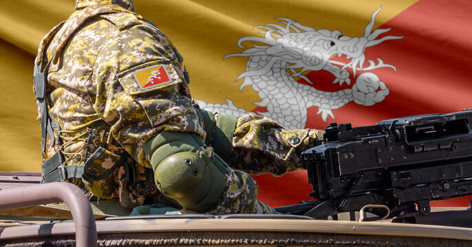 Bhutan flag with soldier at machine gun turret in front of it. Closeup side view.