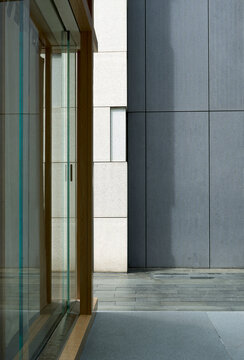 Urban architecture showcasing concrete and glass surfaces with strong shadows