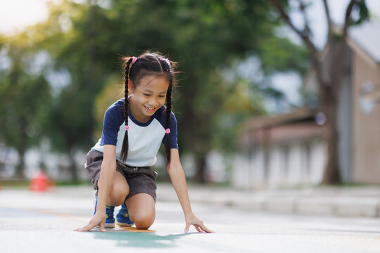 Little girl runner on starting line preparing for race