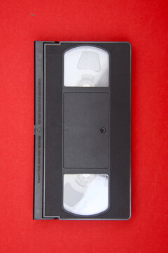 Black video home system tape showing two reels and flat surface, symbolizing retro technology and old media