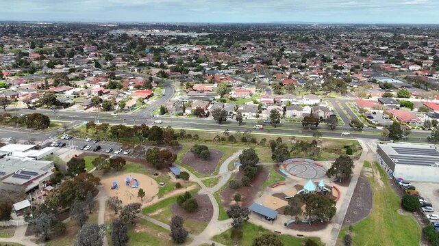 Aerial view of a suburban park, playground, and sports field surrounded by residential homes and roads. Hoppers Crossing, Melbourne, Australia. Community recreation outdoor space