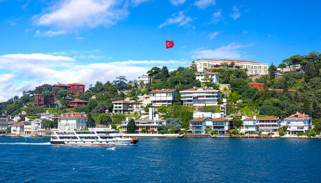 Bosphorus strait with istanbul waterfront houses and turkish flag