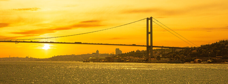 Bosphorus bridge spanning golden bosphorus strait at sunset