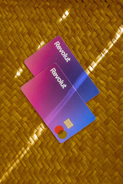 two Revolut debit card lying flat on a natural surface