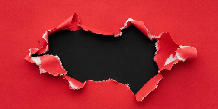 Torn red paper frame with black space in the center  
