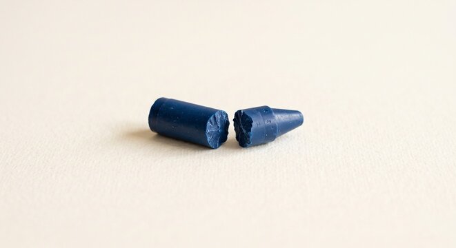 Broken Blue Wax Crayon in Two Pieces on Neutral Background
