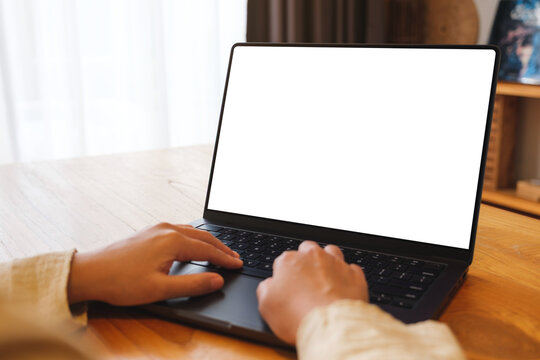 Mockup image of a woman working and typing on laptop computer with blank screen at home