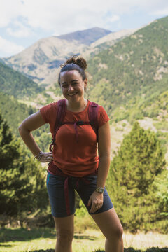 Woman smiling enjoying mountain hiking adventure