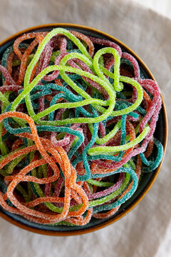 Colorful Spaghetti Jelly Candies Sprinkled with Sugar in a Bowl, top view. Close-up.