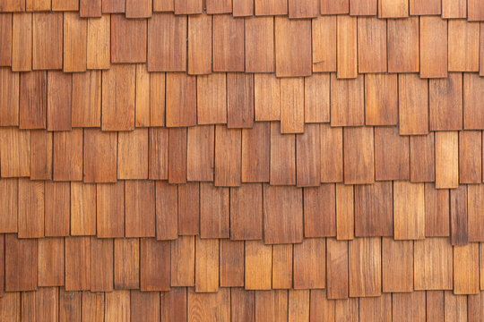 Full frame background texture of rustic weathered wooden shingles pattern.