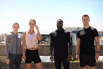 Fototapeta premium Portrait, athlete and group in city with fitness for challenge, competition or commitment for health. Runner, club and serious people with space for sports, workout or training together for marathon