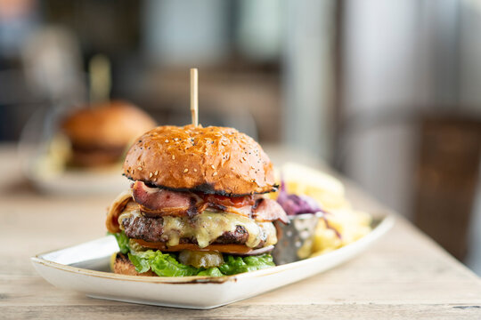 Delicious Burger Stacked High With Toppings Awaits Enjoyment