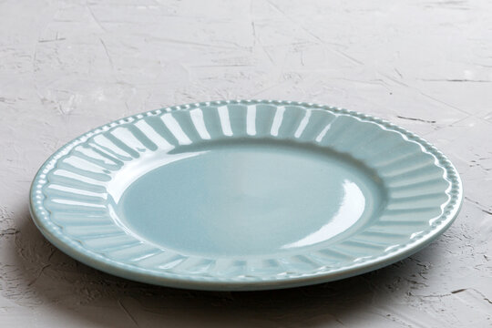 Perspective view of empty grey plate on cement background. Empty space for your design