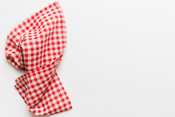Obraz premium top view with red empty kitchen napkin isolated on table background. Folded cloth for mockup with copy space, Flat lay. Minimal style