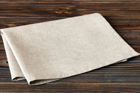 top view with gray kitchen napkin isolated on table background. Folded cloth for mockup with copy space, Flat lay. Minimal style