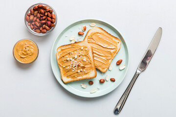 Obraz premium Peanut butter sandwiches or toasts on light table background.Breakfast. Vegetarian food. American cuisine top view vith copy space
