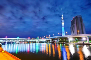  View of the Tokyo skyline along the river at night in Tokyo. © Javen